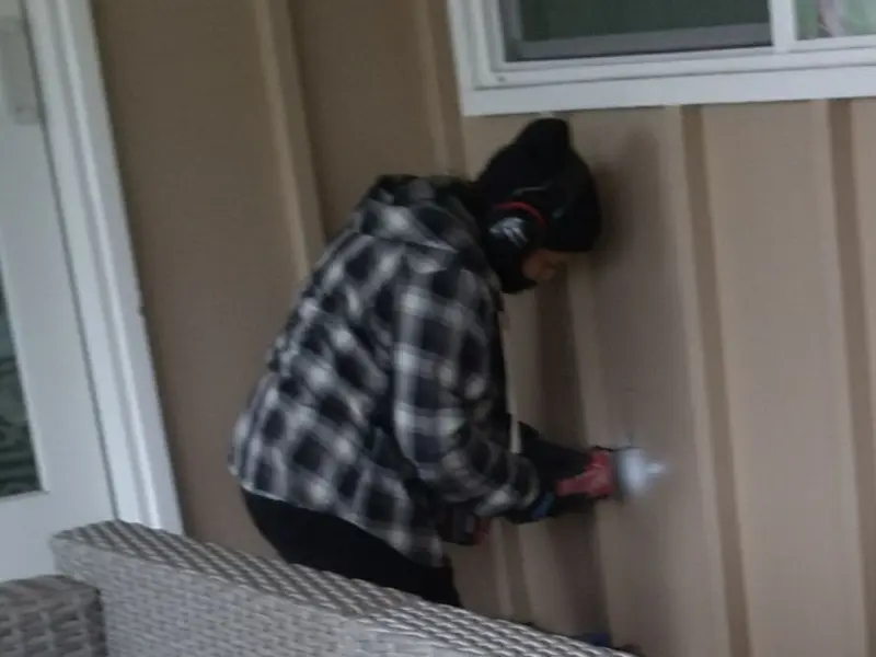 Professional electrician installing an exterior outlet in Live Oak