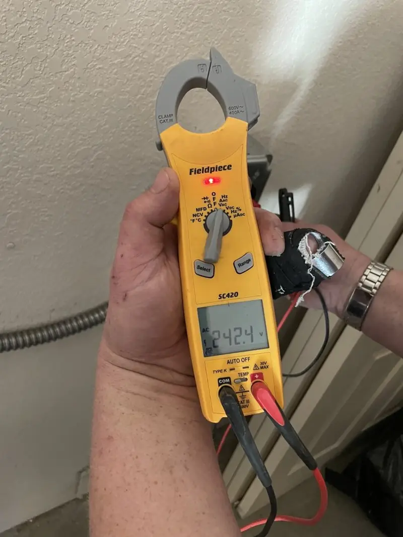 Voltage testing with clamp meter during Electrical Installation Services in Live Oak